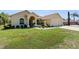 Charming single-story home with a well-manicured lawn and a three car garage at 5202 Lydia Ct, Spring Hill, FL 34608