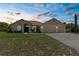 Charming home featuring manicured lawn, water fountain, and spacious three-car garage at 5202 Lydia Ct, Spring Hill, FL 34608