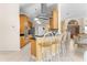 Bright kitchen area with wooden cabinets, stainless steel appliances, black countertops, and a breakfast bar with seating at 5202 Lydia Ct, Spring Hill, FL 34608