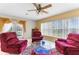 Living room featuring recliners, tile flooring, and a window overlooking the backyard at 5202 Lydia Ct, Spring Hill, FL 34608