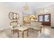 Elegant living room featuring ornate seating, tile floors, and chandelier lighting at 5202 Lydia Ct, Spring Hill, FL 34608