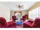 Living room featuring recliners, tile flooring, and a window overlooking the backyard at 5202 Lydia Ct, Spring Hill, FL 34608