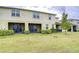 Townhome backyard featuring a lawn and screened-in patio, perfect for relaxing and entertaining at 10822 Verawood Dr, Riverview, FL 33579