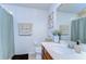 Well-maintained bathroom with dark wood vanity, white sink, framed mirror, and shower-tub combination at 10822 Verawood Dr, Riverview, FL 33579