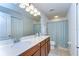Bright bathroom featuring a double sink vanity, framed mirror, and shower-tub combination at 10822 Verawood Dr, Riverview, FL 33579