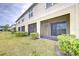 View of the home's exterior featuring a screened in lanai and well-maintained lawn at 10822 Verawood Dr, Riverview, FL 33579
