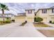 Inviting townhome featuring a light yellow facade, two-car garage, and well-maintained landscaping, creating an appealing curb appeal at 10822 Verawood Dr, Riverview, FL 33579