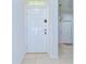 Bright foyer with neutral tile floors, a white front door, and a view into the home at 10822 Verawood Dr, Riverview, FL 33579