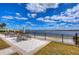 Outdoor patio with elegant seating and umbrella offering breathtaking panoramic lake views on a sunny day at 10822 Verawood Dr, Riverview, FL 33579