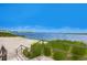 Beautiful view of the lake from the sandy beach area with decorative foliage leading to calm waters at 10822 Verawood Dr, Riverview, FL 33579