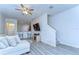 Bright living room with eat-in kitchen, entertainment center, comfortable sectional sofa, and stairs at 10822 Verawood Dr, Riverview, FL 33579