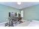 Functional office space with modern computer setup, futon, and neutral color scheme at 10822 Verawood Dr, Riverview, FL 33579
