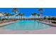 Community pool featuring ample seating, and resort-style amenities surrounded by lush landscaping at 10822 Verawood Dr, Riverview, FL 33579
