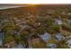 Gorgeous aerial view showcasing the property nestled among lush greenery, with views of the water in the distance at 1136 Serpentine S Dr, St Petersburg, FL 33705