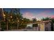 Backyard view at dusk showcasing the outdoor movie screen, fire pit, and string lights at 1136 Serpentine S Dr, St Petersburg, FL 33705