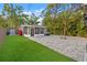 Backyard with lush landscaping, paved patio, hot tub, fire pit, and outdoor lighting at 1136 Serpentine S Dr, St Petersburg, FL 33705