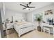 Bright bedroom with white furnishings, a ceiling fan, and a window with natural light at 1136 Serpentine S Dr, St Petersburg, FL 33705