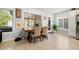 Cozy dining area with a wooden table, comfortable seating, and bright natural light streaming through the windows at 1136 Serpentine S Dr, St Petersburg, FL 33705