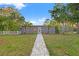 Charming single-story home features a well-maintained yard with a welcoming walkway and lush tropical landscaping at 1136 Serpentine S Dr, St Petersburg, FL 33705