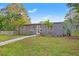 Inviting single-story home with tropical landscaping, green lawn, and a charming walkway to the front door at 1136 Serpentine S Dr, St Petersburg, FL 33705