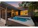 Inviting outdoor hot tub with ambient blue lighting and adjacent screened-in patio, perfect for relaxation and entertainment at 1136 Serpentine S Dr, St Petersburg, FL 33705