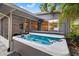 Hot tub on patio with outdoor fan, adjacent to a screened patio at 1136 Serpentine S Dr, St Petersburg, FL 33705