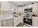 Well-equipped kitchen with stainless steel appliances, white subway tile, and stylish fixtures at 1136 Serpentine S Dr, St Petersburg, FL 33705