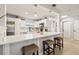 Modern kitchen with white cabinets, stainless steel appliances, a quartz countertop bar, and pendant lighting at 1136 Serpentine S Dr, St Petersburg, FL 33705