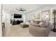 Stylish living room with a large flat-screen TV, modern furnishings, and windows showcasing the lovely outdoors at 1136 Serpentine S Dr, St Petersburg, FL 33705