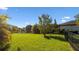 Spacious backyard features a manicured lawn and calming lake views at 11412 Autumn Leaf Way, Bradenton, FL 34212