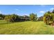 Large backyard is surrounded by a black aluminum fence and tropical landscaping at 11412 Autumn Leaf Way, Bradenton, FL 34212