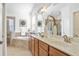 Stylish bathroom showcasing double sinks, granite countertops, and a large framed mirror at 11412 Autumn Leaf Way, Bradenton, FL 34212