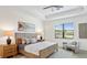 Bright bedroom with tray ceilings, a large window, neutral decor and stylish furnishings for a comfortable and relaxing retreat at 11412 Autumn Leaf Way, Bradenton, FL 34212