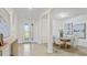 Bright and airy foyer leads into the dining room, showcasing an open-concept design at 11412 Autumn Leaf Way, Bradenton, FL 34212