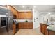Well-equipped kitchen with stainless steel appliances, granite countertops, and ample wooden cabinetry offering lots of storage at 11412 Autumn Leaf Way, Bradenton, FL 34212