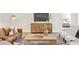 Comfortable living room with stylish decor, featuring a leather sofa, decorative table, and a modern console table at 11412 Autumn Leaf Way, Bradenton, FL 34212