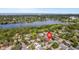 Breathtaking aerial view of a lakeside community surrounded by lush green trees and serene blue waters, offering a peaceful retreat at 1250 12Th Sw Ct, Largo, FL 33770