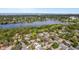 An aerial view of homes and a large lake in the distance, showcasing neighborhood and natural beauty at 1250 12Th Sw Ct, Largo, FL 33770