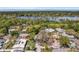 Aerial view showcases a residential neighborhood with large lake and lush trees at 1250 12Th Sw Ct, Largo, FL 33770