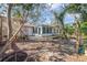 Exterior of home showcasing the sunroom, patio area, and lush landscaping of the backyard at 1250 12Th Sw Ct, Largo, FL 33770