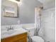 Updated bathroom with wood vanity, toilet, shower and tub combination, and a large mirror at 1250 12Th Sw Ct, Largo, FL 33770