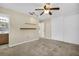 Spacious bedroom with carpeted floors, ceiling fan, closet, and access to the ensuite bathroom at 1250 12Th Sw Ct, Largo, FL 33770
