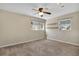 Neutral bedroom features carpet, a ceiling fan, and two windows to let in natural light at 1250 12Th Sw Ct, Largo, FL 33770