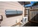 Exterior of the home featuring an air conditioning unit and wooden fence at 1250 12Th Sw Ct, Largo, FL 33770