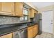Updated kitchen featuring stainless steel appliances, granite countertops, and efficient layout for modern convenience at 1250 12Th Sw Ct, Largo, FL 33770