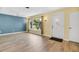 A spacious living room features new wood-look floors, large window with natural light, and neutral wall colors at 1250 12Th Sw Ct, Largo, FL 33770