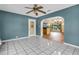 Sun-lit living room with tile floors and a ceiling fan looks into the dining room and the front entry at 1250 12Th Sw Ct, Largo, FL 33770