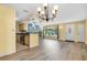 The house has an open concept living space with wood-look floors, plenty of natural light and an eat-in kitchen at 1250 12Th Sw Ct, Largo, FL 33770