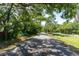 Street view showcasing mature trees lining the road and a serene neighborhood atmosphere at 1250 12Th Sw Ct, Largo, FL 33770