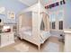 Bedroom with decorative canopy bed and accent ribbons and trim at 1403 W Watrous Ave, Tampa, FL 33606